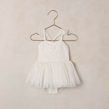 Load image into Gallery viewer, White children's dress with a tutu on a hanger against a beige wall