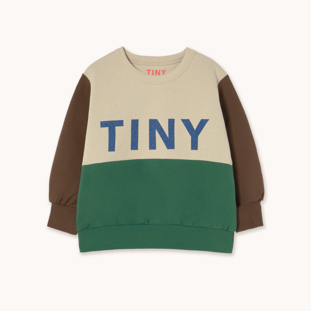 Color-blocked sweater with 'TINY' text on a white background