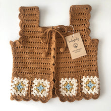 Load image into Gallery viewer, A pair of handmade brown crochet boot covers with scalloped edges and white, blue, and yellow granny square accents, shown on a white background with a paper tag attached.

