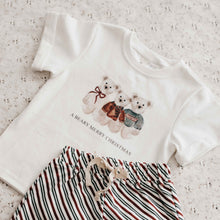 Load image into Gallery viewer, White t-shirt with Christmas design and striped shorts on a light background
