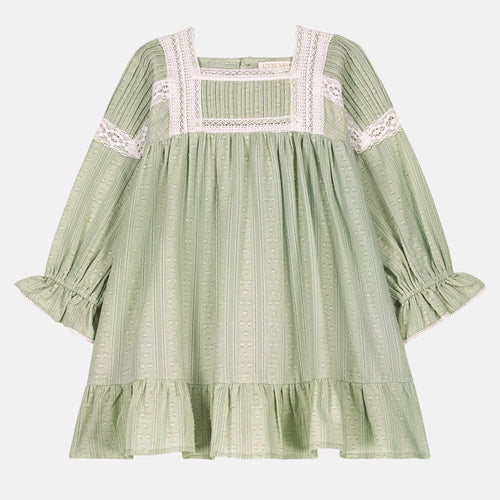 Green dress with lace details on a white background