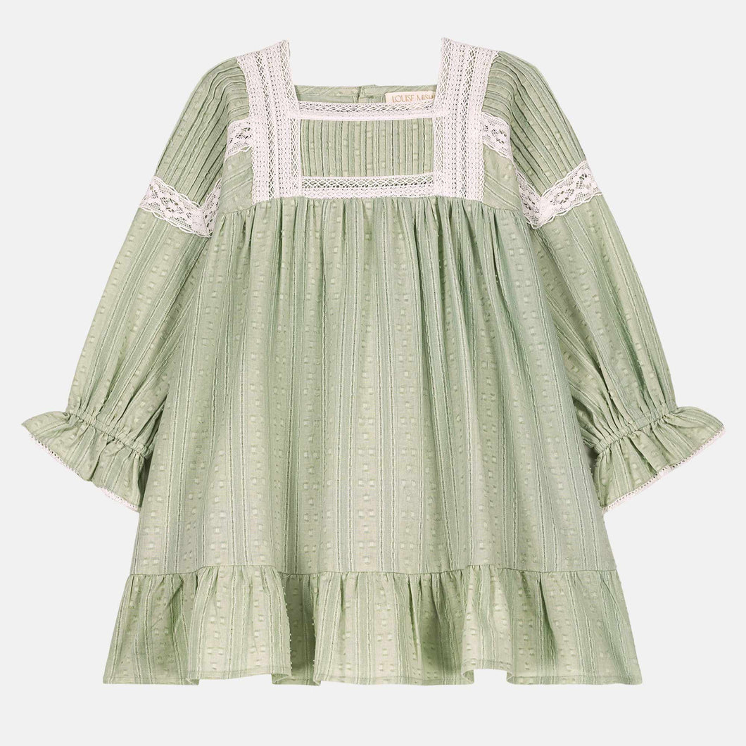 Green dress with lace details on a white background