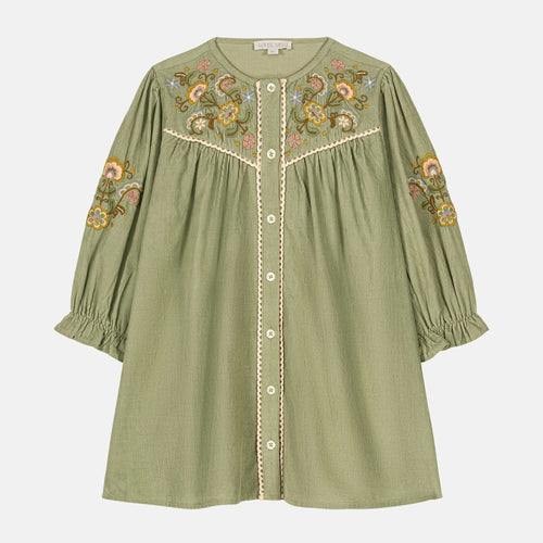 Green dress with floral embroidery on a white background