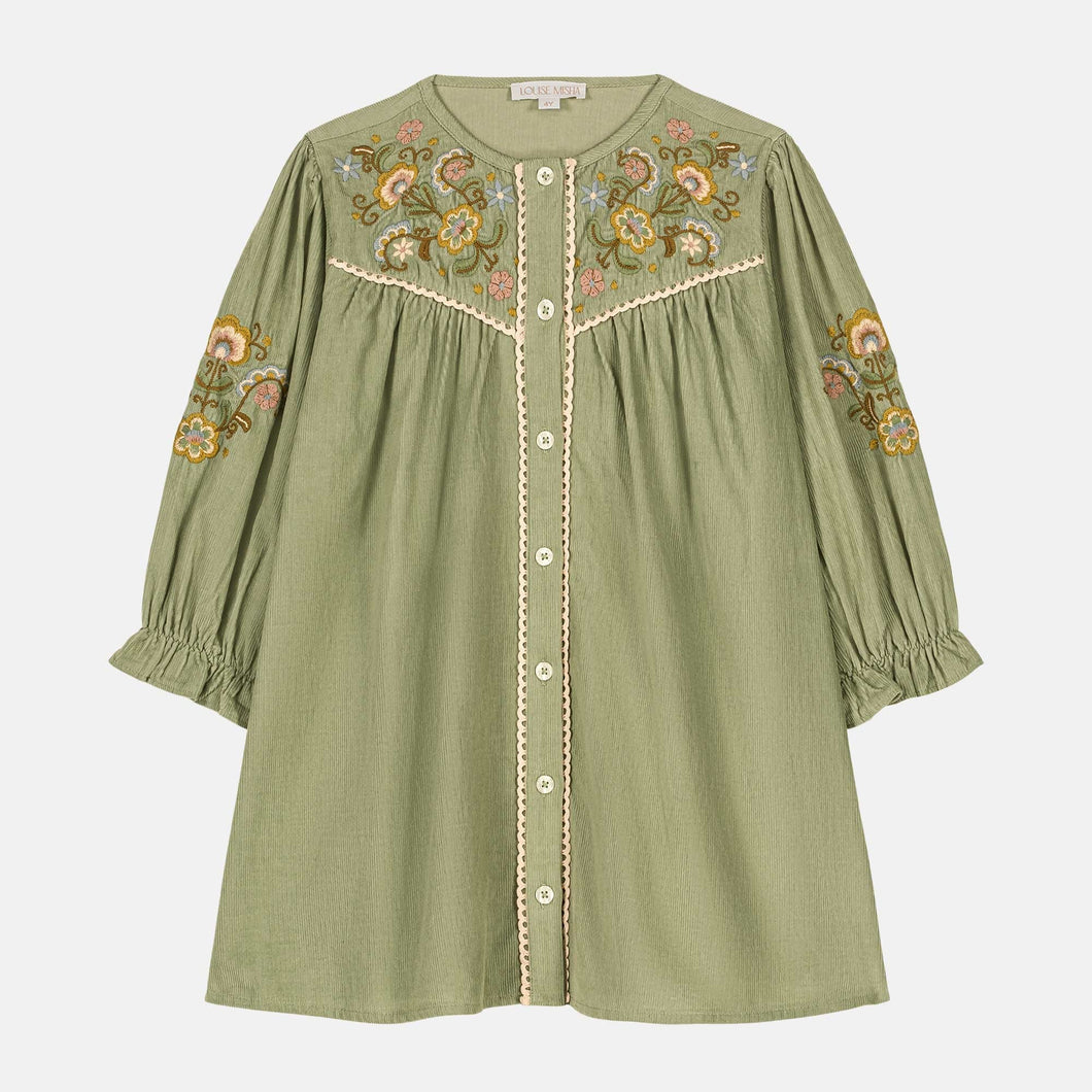 Green dress with floral embroidery on a white background