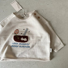 Load image into Gallery viewer, White children's shirt with graphic design and text on a gray surface
