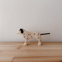 Load image into Gallery viewer, Wooden dog toy with black spots on a wooden surface

