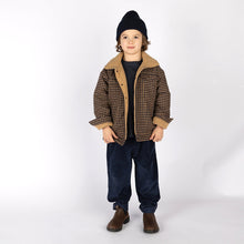 將圖片載入圖庫檢視器 Child wearing a plaid jacket, black beanie, and dark pants on a white background
