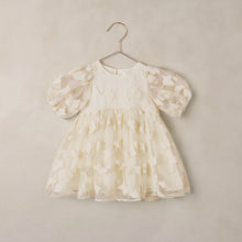 Load image into Gallery viewer, White floral dress on a hanger against a beige background

