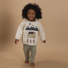 Load image into Gallery viewer, Child wearing a sweater with a nature-themed design on a beige background
