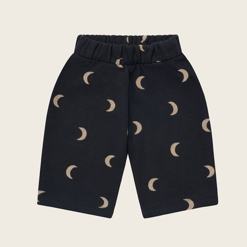 Black pants with moon pattern on a beige background