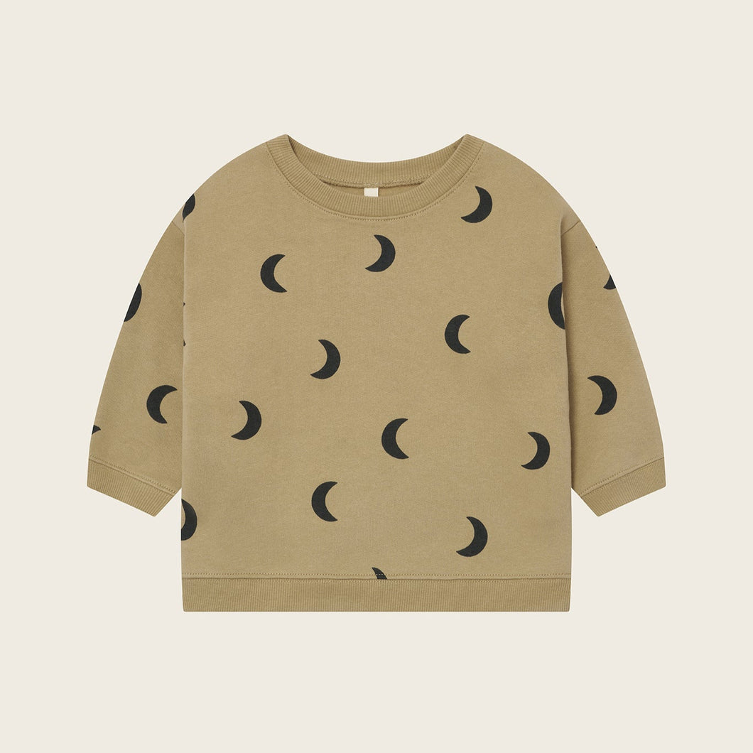 Beige sweatshirt with black moon pattern on a beige background