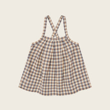 Load image into Gallery viewer, Plaid dress with suspenders on a beige background
