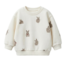 將圖片載入圖庫檢視器 An off-white long-sleeve crewneck sweatshirt featuring a repeating pattern of small gray-brown rabbits with tiny red accents, displayed on a clean white background.
