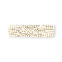 將圖片載入圖庫檢視器 A cream-colored fabric headband with a thin tan grid pattern and a matching knotted bow in the center, displayed on a clean white background.
