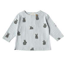 Load image into Gallery viewer, A light blue ribbed long-sleeve top with a repeating gray bunny print, displayed flat against a white background.
