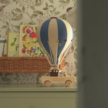 Load image into Gallery viewer, Decorative hot air balloon model on a wooden truck against a floral wallpaper background
